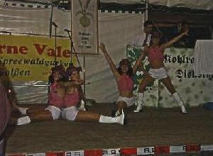Tänzerinnen führen eine Show auf der Bühne mit Bannern durch